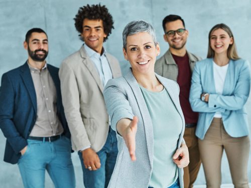 Group of young business people having a meeting shaking hands handshake introducing each other in the office. Teamwork and success concept